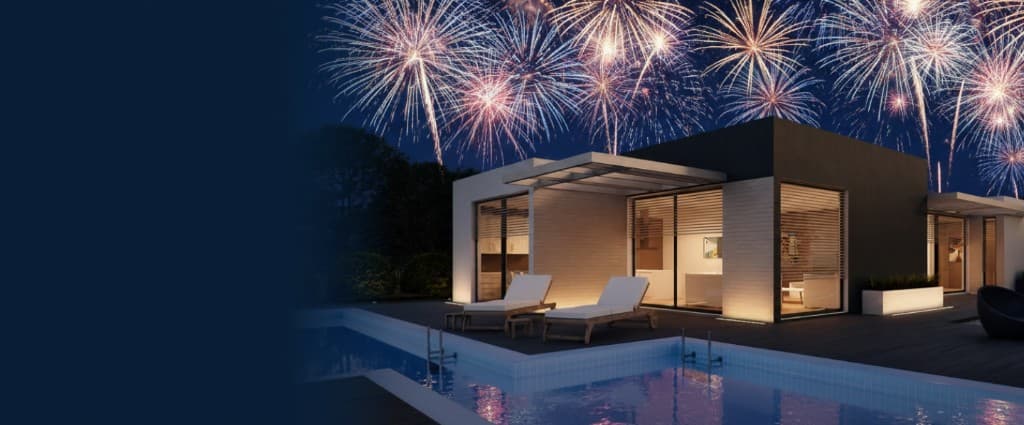 Modern vacation rental lit up at night with fireworks overhead celebrating July 4th